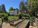 Exterior garden beds, lush landscaping and home featuring a brick chimney and covered patio at 8535 E Otero Cir, Centennial, CO 80112