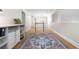 Upstairs hallway with hardwood floors, natural lighting, storage shelves, and a wooden banister at 8535 E Otero Cir, Centennial, CO 80112