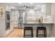 Spacious kitchen features stainless steel appliances, hardwood floors and granite countertops with seating at 8535 E Otero Cir, Centennial, CO 80112
