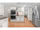Updated kitchen featuring stainless steel appliances, sleek cabinetry, and hardwood flooring at 8535 E Otero Cir, Centennial, CO 80112