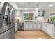 Modern kitchen with stainless steel appliances, granite countertops, and white cabinets at 8535 E Otero Cir, Centennial, CO 80112