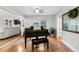 Stylish living room area highlighting a grand piano, hardwood floors, and seamless flow between rooms at 8535 E Otero Cir, Centennial, CO 80112