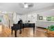 Living space with a piano, hardwood floors, staircase and an open layout flowing into adjacent rooms at 8535 E Otero Cir, Centennial, CO 80112