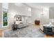 Spacious living room featuring soaring ceilings, large windows, hardwood floors, and elegant furniture at 8535 E Otero Cir, Centennial, CO 80112