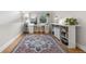 Office features an area rug, a large desk, natural lighting, and hardwood floors at 8535 E Otero Cir, Centennial, CO 80112