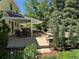 Inviting patio with outdoor dining and seating areas, complemented by lush landscaping and a decorative stone fire pit at 8535 E Otero Cir, Centennial, CO 80112
