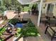 Extended brick patio with fire pit, covered seating area, koi pond, and lush landscaping at 8535 E Otero Cir, Centennial, CO 80112