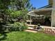 Picturesque patio area showcasing a rock garden, lush landscaping, comfortable seating, and a tranquil water feature at 8535 E Otero Cir, Centennial, CO 80112