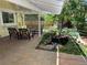 Relaxing covered patio featuring comfortable seating, lush landscaping, and a tranquil koi pond for outdoor enjoyment at 8535 E Otero Cir, Centennial, CO 80112