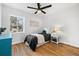 Sun-lit bedroom with hardwood floors, a ceiling fan and a large window at 1812 S Hazel Ct, Denver, CO 80219