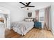 Bright bedroom features a ceiling fan, hardwood floors and a blue dresser at 1812 S Hazel Ct, Denver, CO 80219