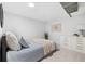 Bright bedroom with a large bed, soft pillows, neutral colored linens and a white dresser at 1812 S Hazel Ct, Denver, CO 80219