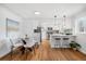 Stylish kitchen with modern appliances, white cabinets, and a dining area at 1812 S Hazel Ct, Denver, CO 80219