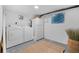 Convenient laundry room featuring a washer, dryer, and fridge, plus a decorative accent wall at 1812 S Hazel Ct, Denver, CO 80219