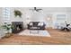 Inviting living room featuring a fireplace, hardwood floors, and abundant natural light at 1812 S Hazel Ct, Denver, CO 80219