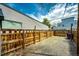 Fenced backyard with gravel ground cover and partial grass; possible dog run at 444 Inca St, Denver, CO 80204