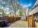 Fenced backyard with gravel ground cover and partial grass; possible dog run at 444 Inca St, Denver, CO 80204