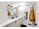 Modern bathroom featuring double vanity, updated lighting fixtures, and patterned tile floors at 444 Inca St, Denver, CO 80204