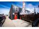 Exterior view of a commercial building with a red door and mural at 444 Inca St, Denver, CO 80204