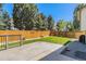 A well-manicured backyard features a spacious deck, a vibrant lawn, and a sturdy wooden fence for added privacy at 21924 E Lake Ave, Aurora, CO 80015