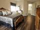 Ornately decorated bedroom with wood floors, matching furniture, and access to bath at 21924 E Lake Ave, Aurora, CO 80015