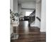 Inviting entryway featuring hardwood floors, stairs to the upper level, and stylish decor at 21924 E Lake Ave, Aurora, CO 80015