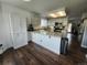 Charming kitchen with granite countertops, white cabinetry, wood floors and stainless appliances at 21924 E Lake Ave, Aurora, CO 80015