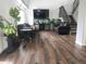 Spacious living room featuring hardwood floors, a large TV, fish tank, and comfortable leather furniture at 21924 E Lake Ave, Aurora, CO 80015