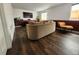 Cozy living room featuring modern entertainment center, hardwood floors, and ample natural light at 21924 E Lake Ave, Aurora, CO 80015