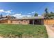 Expansive backyard featuring a lush lawn, mature trees, a private fence, and a covered patio at 9880 W 76Th Pl, Arvada, CO 80005