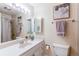 Bathroom features a single sink, white countertops, vanity with drawers, and a mirror with a light fixture at 9880 W 76Th Pl, Arvada, CO 80005