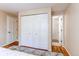 Bedroom with hardwood floors, closet and featuring an open door to an en-suite bathroom with a shower at 9880 W 76Th Pl, Arvada, CO 80005