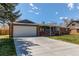 Charming single-story home features brick accents, attached garage, and well-maintained front lawn at 9880 W 76Th Pl, Arvada, CO 80005