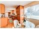 Eat-in kitchen with wooden cabinets, stainless steel appliances, and bright natural light at 9880 W 76Th Pl, Arvada, CO 80005