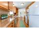 Kitchen featuring wood cabinets, countertops, and stainless steel appliances at 9880 W 76Th Pl, Arvada, CO 80005