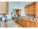 Open-concept kitchen with modern appliances and ample counter space at 9880 W 76Th Pl, Arvada, CO 80005