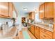Well-lit kitchen with wood cabinets and countertops at 9880 W 76Th Pl, Arvada, CO 80005