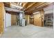 Unfinished basement with water heater, shelving, and concrete floors at 4545 Oxbow Dr, Brighton, CO 80601