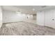 Spacious basement with wood-look flooring, an open doorway, and recessed lights at 4545 Oxbow Dr, Brighton, CO 80601
