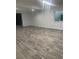 Spacious basement area with modern flooring and natural light from the window at 4545 Oxbow Dr, Brighton, CO 80601