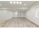 Spacious finished basement with wood-look floors, white walls, recessed lighting and double doors at 4545 Oxbow Dr, Brighton, CO 80601