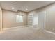 Basement bedroom with gray carpet, a window, and an open doorway to another room at 4545 Oxbow Dr, Brighton, CO 80601