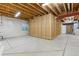 Unfinished basement featuring concrete floors and exposed wood ceiling at 4545 Oxbow Dr, Brighton, CO 80601