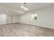 Finished basement features wood-look floors, white walls, a window, and double glass doors at 4545 Oxbow Dr, Brighton, CO 80601