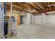 Unfinished basement with water heater, exposed pipes, and unfinished ceiling at 4545 Oxbow Dr, Brighton, CO 80601