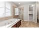 Relaxing bathroom with a soaking tub, separate glass-enclosed shower, and neutral color palette at 4545 Oxbow Dr, Brighton, CO 80601