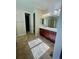 Bathroom featuring a double vanity and a separate area with a walk-in closet and toilet at 4545 Oxbow Dr, Brighton, CO 80601