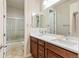 Bright bathroom featuring a double sink vanity with granite counters and a shower over tub at 4545 Oxbow Dr, Brighton, CO 80601