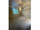Large bedroom with carpeted floors, a ceiling fan, and natural light from a window at 4545 Oxbow Dr, Brighton, CO 80601