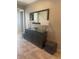 Stylish entryway featuring a dark wood console table with lamps, mirror, and decorative accents at 4545 Oxbow Dr, Brighton, CO 80601